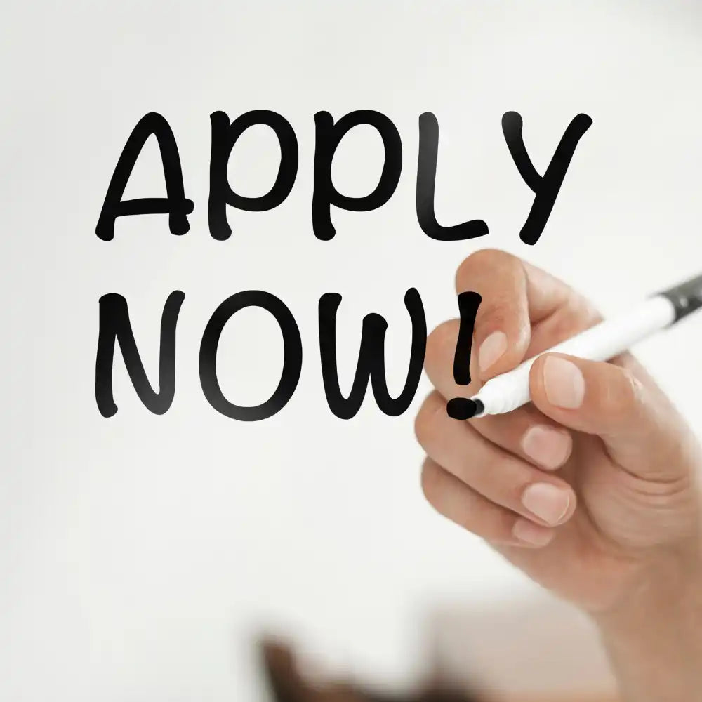 Hand writing ’APPLY NOW!’ with a marker.