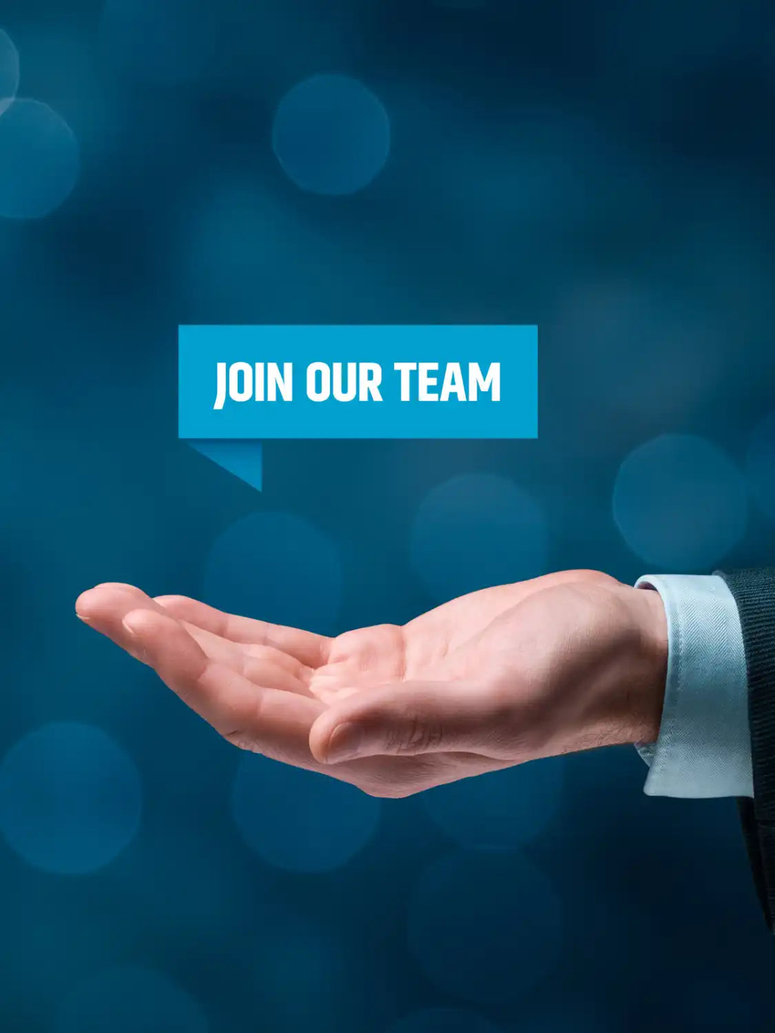 A hand in a business suit sleeve holds up a floating blue ’JOIN OUR TEAM’ text box.