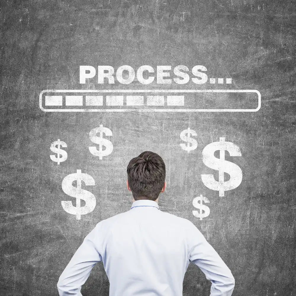 A person in a white shirt stands facing a chalkboard with dollar signs and a loading progress bar.